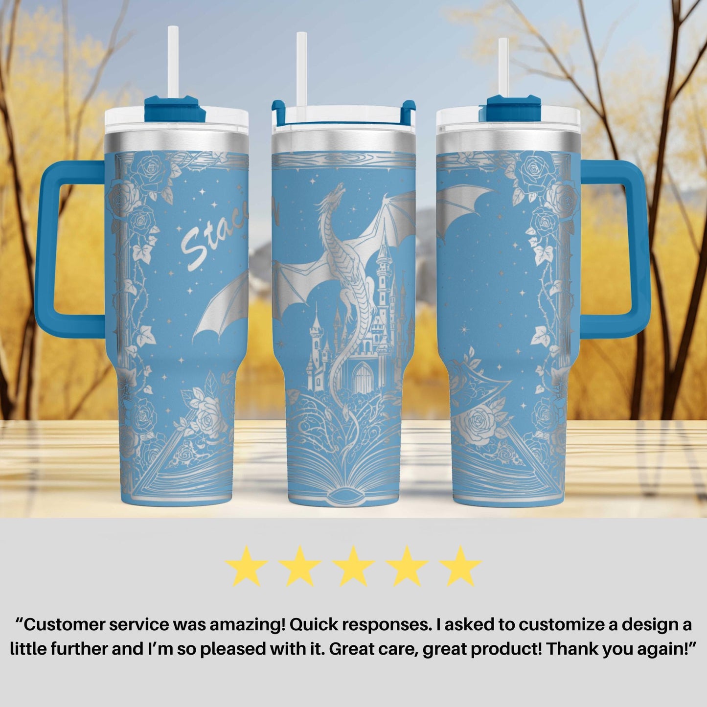 three blue and white tumblers with a dragon design, placed on a wooden surface against a blurred background of trees.