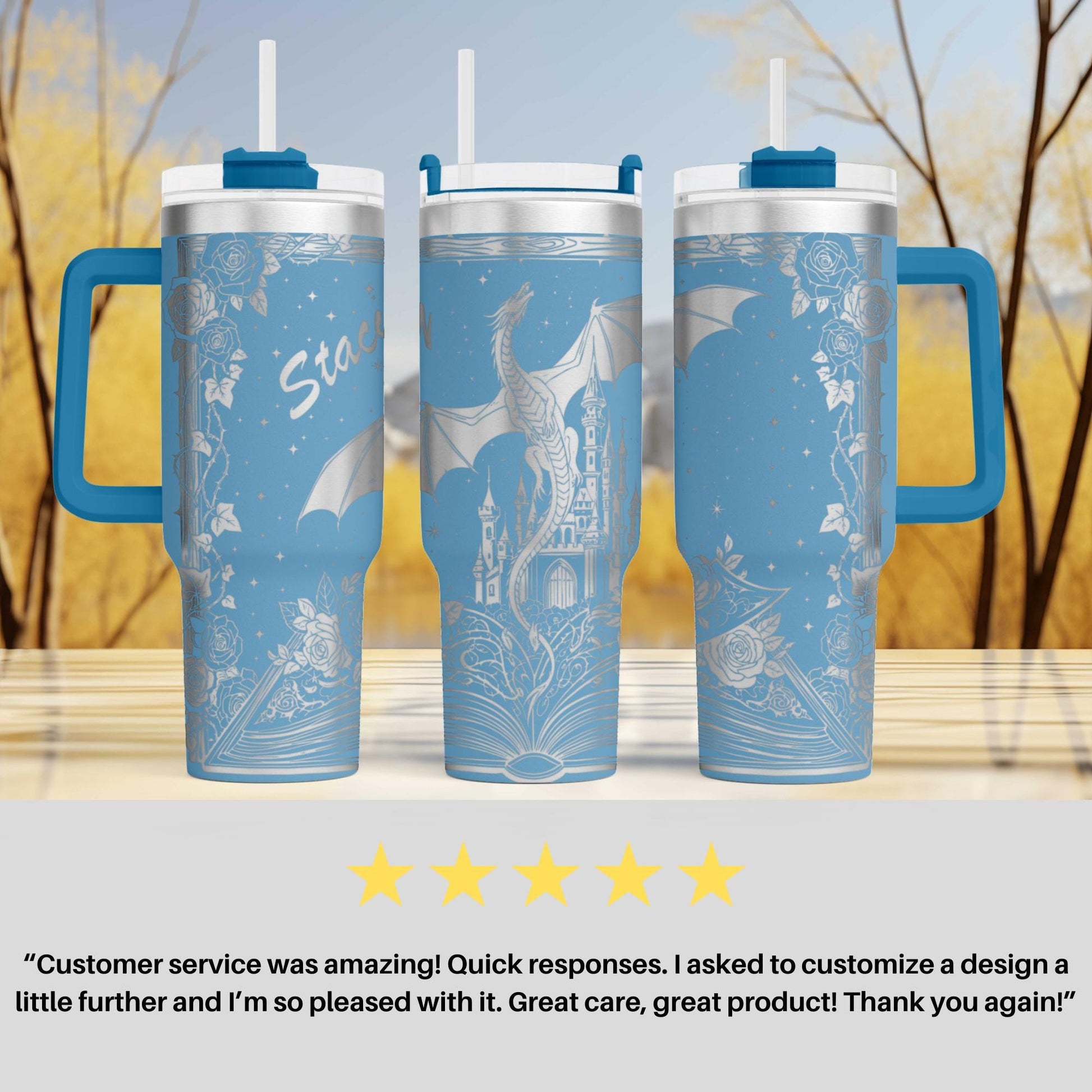 three blue and white tumblers with a dragon design, placed on a wooden surface against a blurred background of trees.