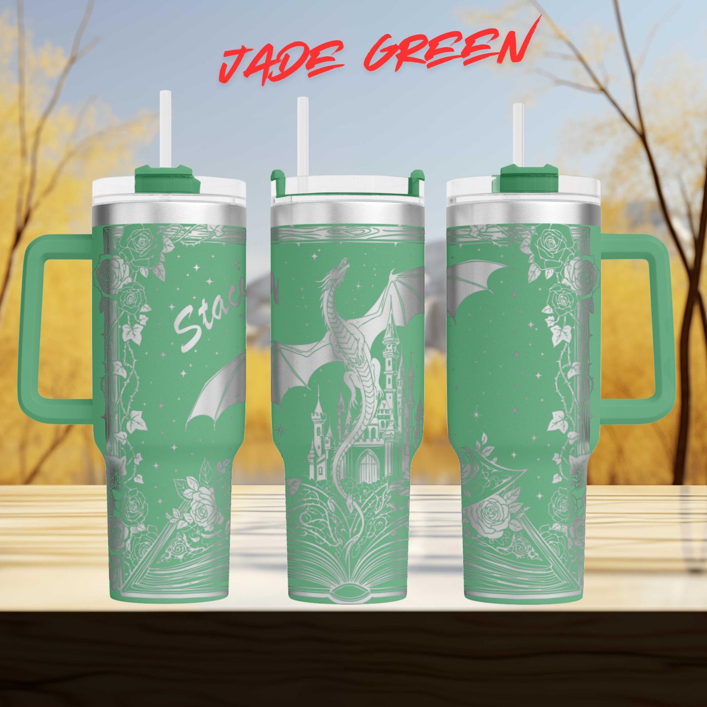 A set of three green tumblers with a dragon design on them, set against a blurred background of trees and sky.