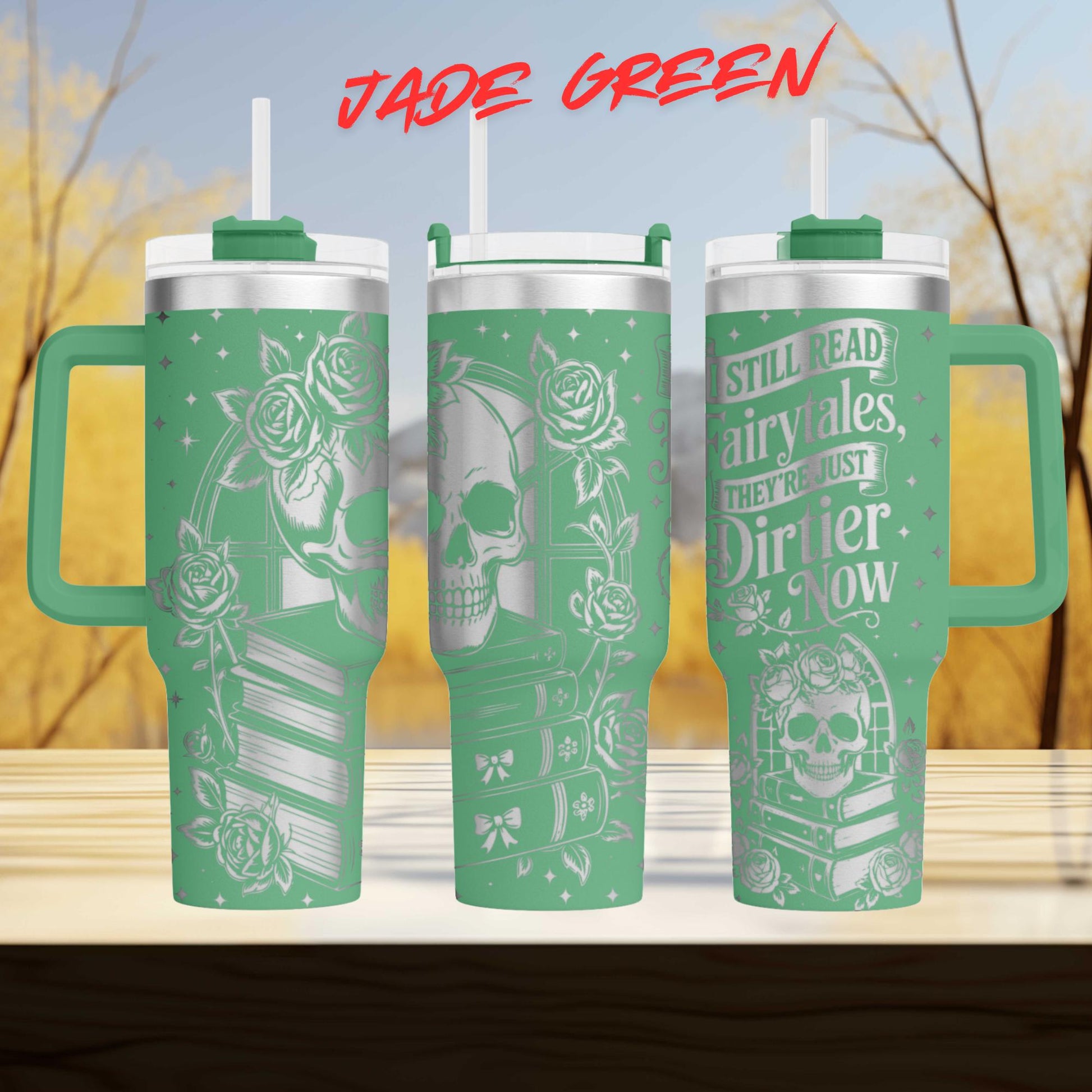A set of three green tumblers with white text and designs on them. The text on the tumblers reads "JADE GREEN" and "STILL READ AIRRYALES, THEY'RE JUST DIRIER NOW".