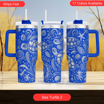 three blue tumblers with a sea turtle design, arranged on a wooden surface against a blurred background.