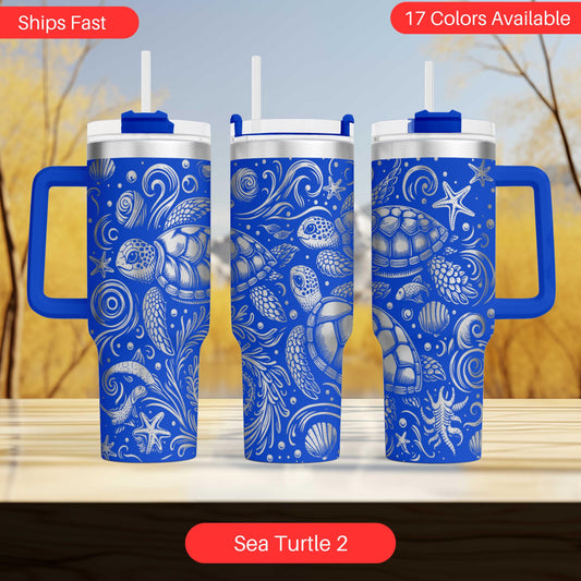 three blue tumblers with a sea turtle design, arranged on a wooden surface against a blurred background.