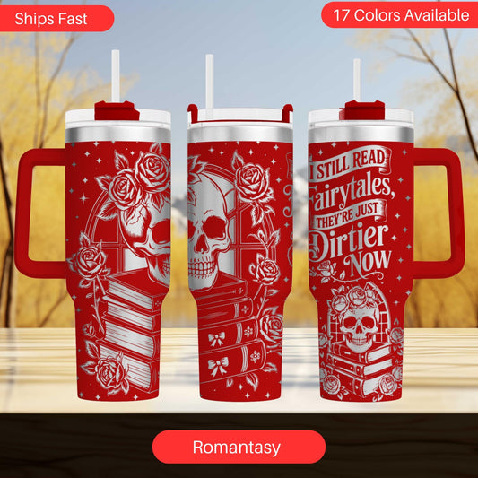 three red tumblers with white designs and text, including a skull and rose motif, against a blurred background of trees.