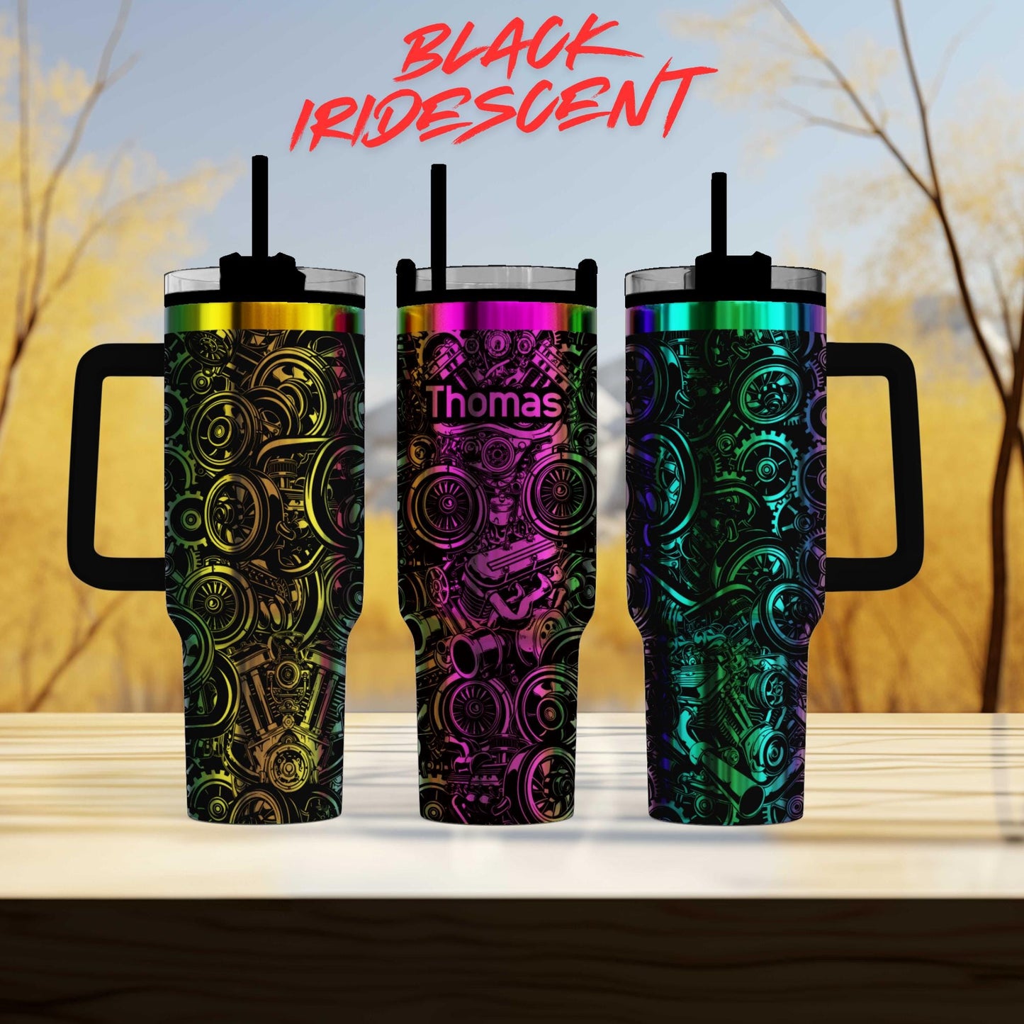 three colorful, patterned tumblers with handles, arranged in a row on a wooden surface.