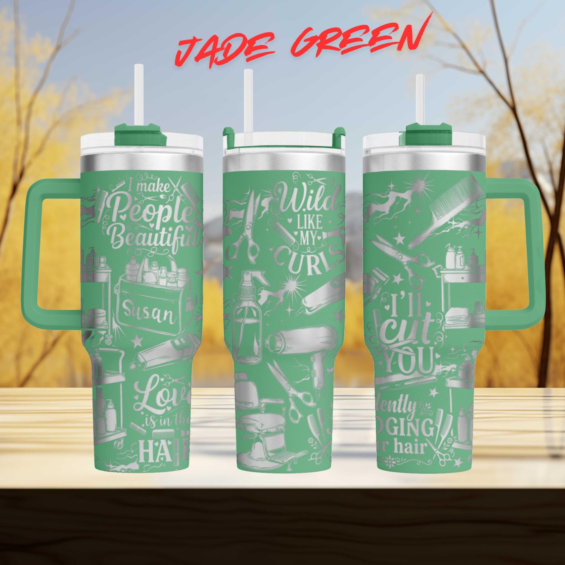 A set of three green tumblers with various text and designs printed on them, set against a blurred background of trees and a blue sky.