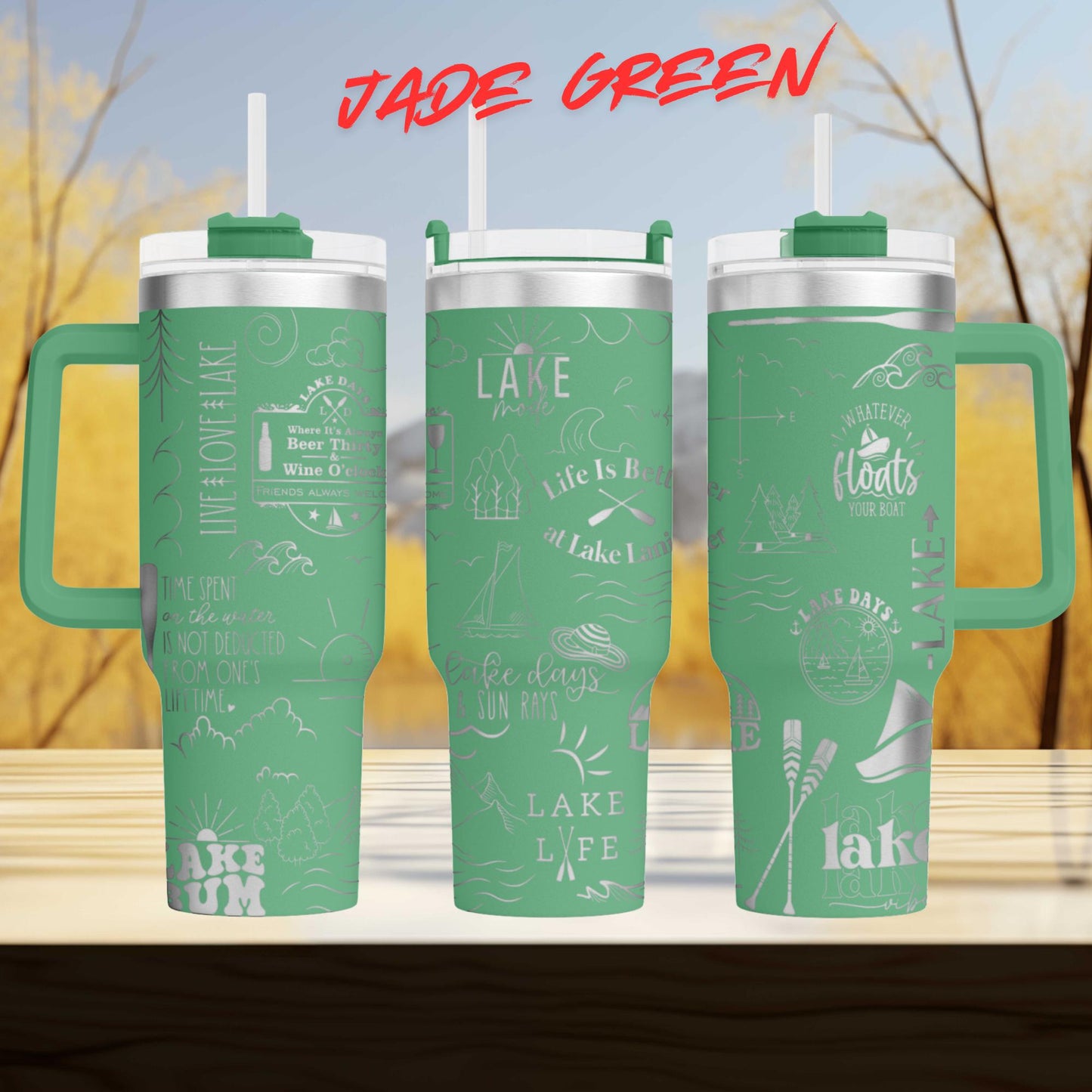 A set of three green tumblers with various text and illustrations printed on them, set against a blurred background of trees and a blue sky.